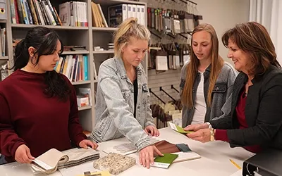 students working on a project with an instructor