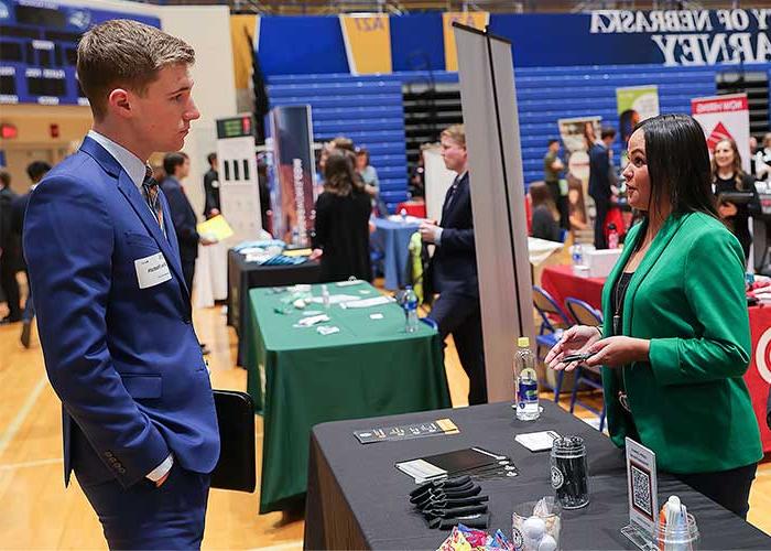 a unk student speaks with an employer at a career fair